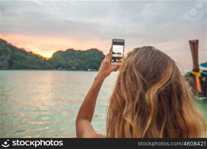 Woman taking photos in Thailand. Woman taking photos with smartphone in Thailand