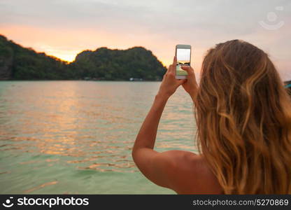 Woman taking photos in Thailand. Woman taking photos with smartphone in Thailand