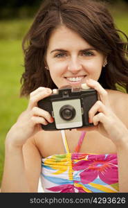 Woman taking pictures in park