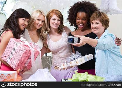 Woman Taking Pictures of women friends at Party