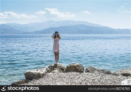 Woman taking pictures with smartphone on the beach.