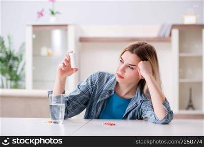 Woman taking pills to cope with pain
