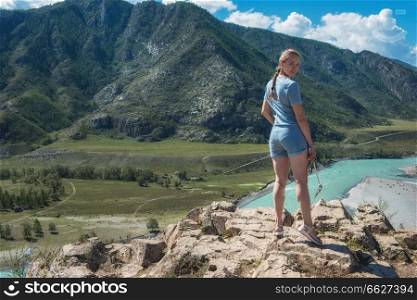 Woman taking selfie on mobile phone with stick. Vacation in the mountain. Woman taking selfie on mobile phone