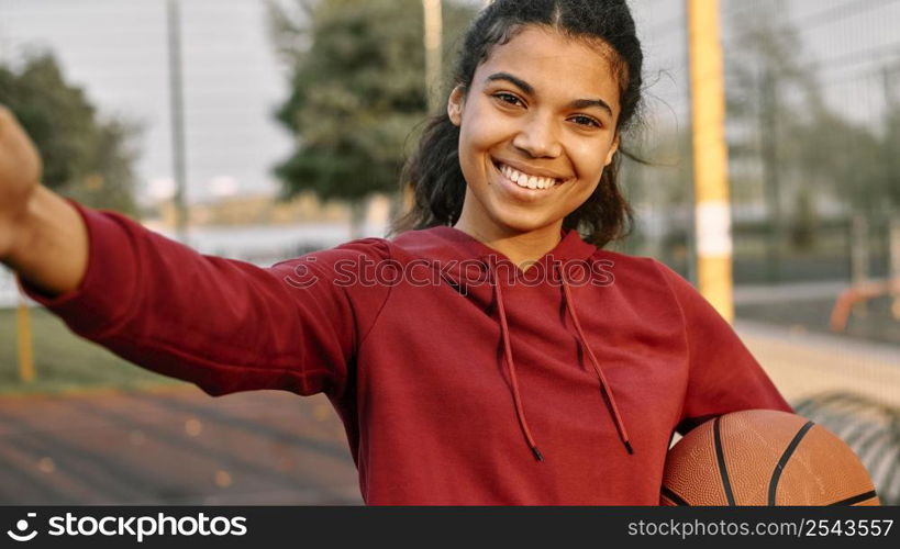 woman taking selfie with basketball 2