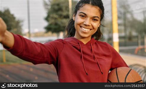 woman taking selfie with basketball 2