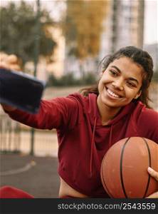 woman taking selfie with her basketball