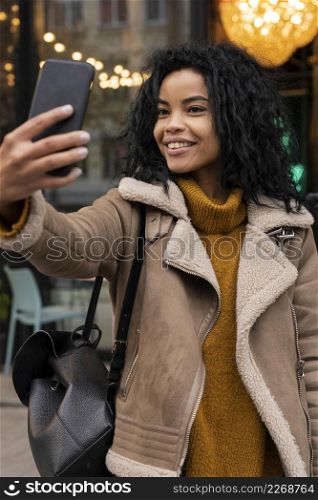 woman taking selfie with her smartphone
