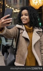 woman taking selfie with her smartphone