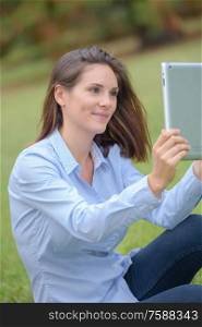 Woman taking selfie with tablet