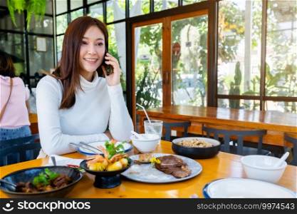 woman talking on a mobile phone in restaurant