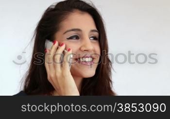 Woman talking on her smart phone.Clerk on mobile conversation.Female phone conversation at work.Corporate business scene with an employee holding a telephone conversation.Cellular phone chatting on white background.