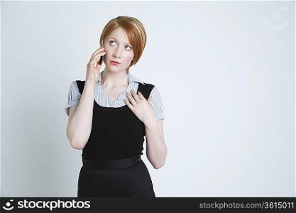 Woman talking on mobile phone on sofa