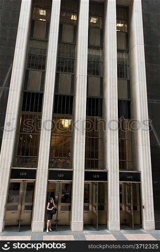Woman talking on the phone outside an office building, Chicago, Cook County, Illinois, USA