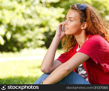 Woman talking over the phone in park