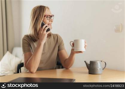 woman talking phone having coffee during quarantine