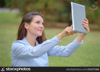 Woman talking self portrait photograph with tablet