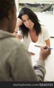 Woman Talking To Counsellor Who Takes Notes