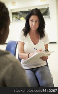 Woman Talking To Counsellor Who Takes Notes