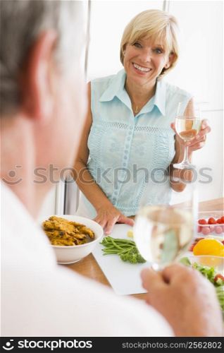 Woman Talking To Husband As She Prepares A meal,mealtime