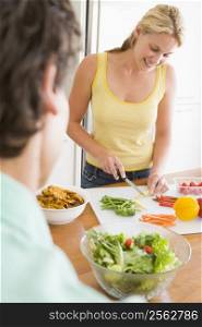 Woman Talking To Husband While Preparing meal,mealtime