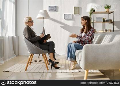 Woman talking to psychologist at psychotherapy session. Patient explaining problem. Mental therapy. Woman patient explaining problem talking to psychologist