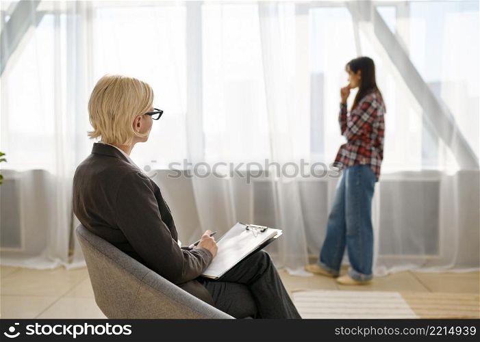 Woman talking to psychologist at psychotherapy session. Patient explaining problem. Mental therapy. Woman patient explaining problem talking to psychologist
