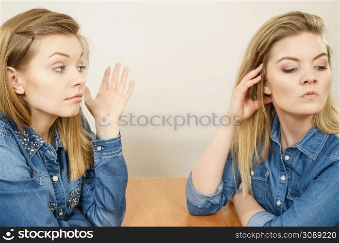 Woman talking with confident ignorant female friend being mad after quarrel, ignoring what she saying.. Woman talking with confident ignorant friend