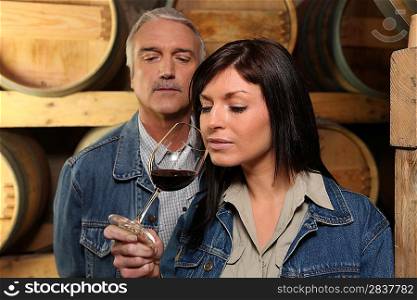 Woman tasting wine in cellar
