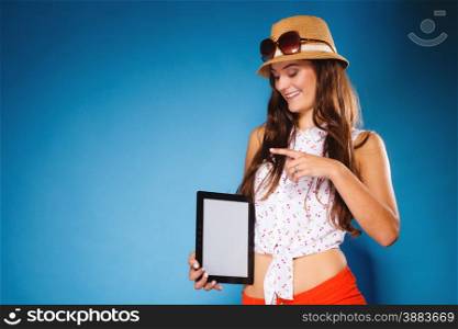 Woman teen girl showing blank copy space screen of tablet touchpad computer on blue. Electronic technology.
