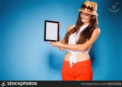 Woman teen girl showing blank copy space screen of tablet touchpad computer on blue. Electronic technology.
