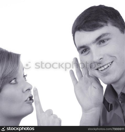 Woman telling man some secrets, couple talking gossiping. Excited emotional girl whispering to boyfriend ear making hush gesture finger on lips