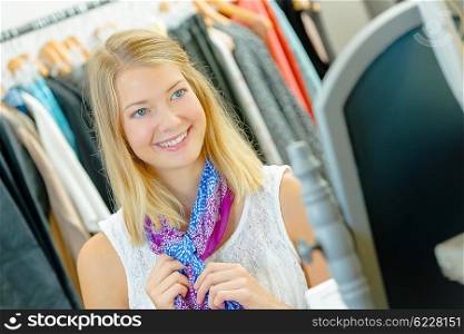 Woman tempted to buy a colourful scarf