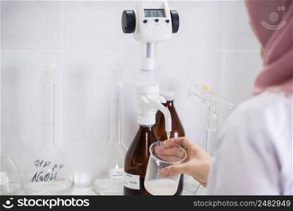 woman testing s&les of dairy products in the laboratory. test laboratory of a milk factory. laboratory of dairy plant