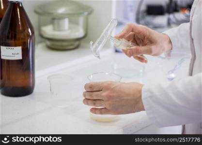 woman testing samples of dairy products in the laboratory. test laboratory of a milk factory. laboratory of dairy plant