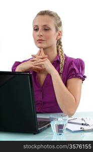 Woman thinking at her laptop