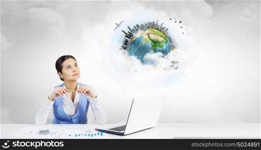 Woman thinking over her project. Young attractive businesswoman sitting at table and thinking something over. Elements of this image are furnished by NASA