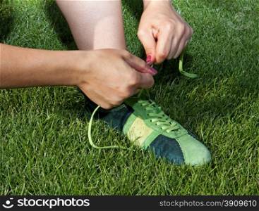 woman ties laces on the sports shoes