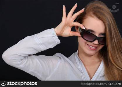 Woman tipping sunglasses