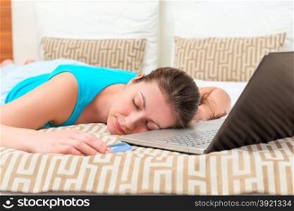 woman tired of shopping online in bed asleep
