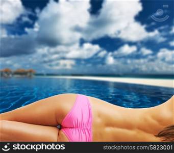 Woman topless at swimming pool in the tropical hotel. Collage.