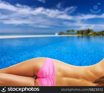 Woman topless at swimming pool in the tropical hotel. Collage.