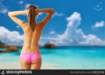 Woman topless on beautiful beach at Seychelles, Praslin, Anse Lazio. Collage.