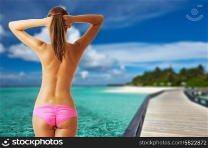 Woman topless on beautiful beach with jetty at Maldives. Collage.