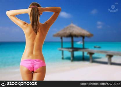 Woman topless on beautiful beach with jetty at Maldives. Collage.