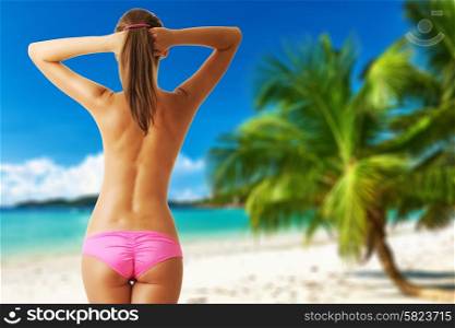 Woman topless on beautiful beach with palm tree at Seychelles, Praslin, Cote d&rsquo;Or. Collage.