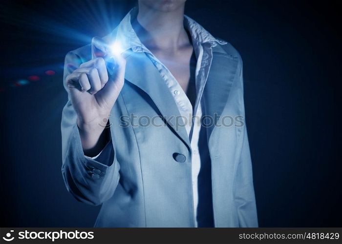 Woman touch light spot. Businesswoman touching light button on blue screen