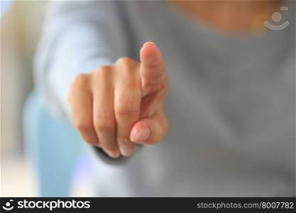 Woman touching an imaginary screen with her finger, used for background