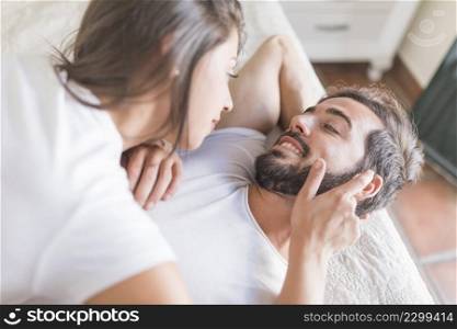 woman touching beard boyfriend