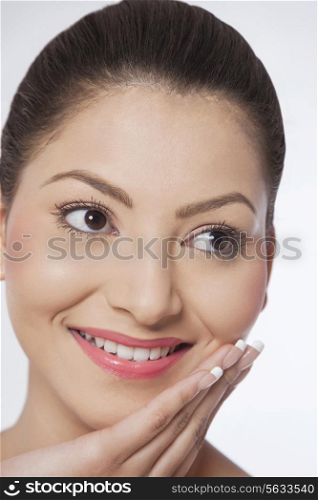 Woman touching her face and looking away