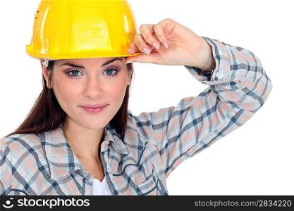 Woman touching the brim of her hard hat